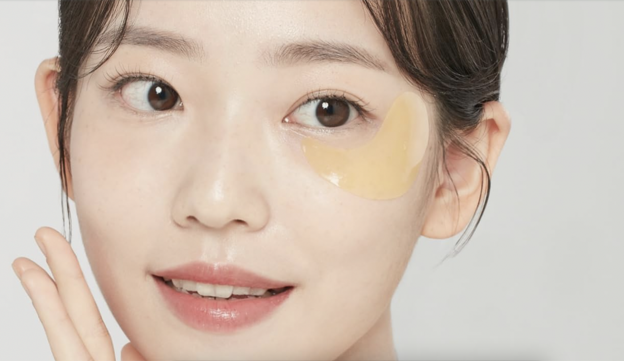 Woman with hydrogel eye patch on her face