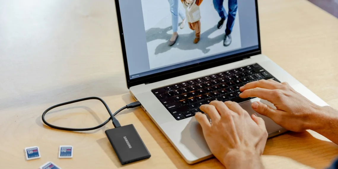 A person using a laptop computer on a table