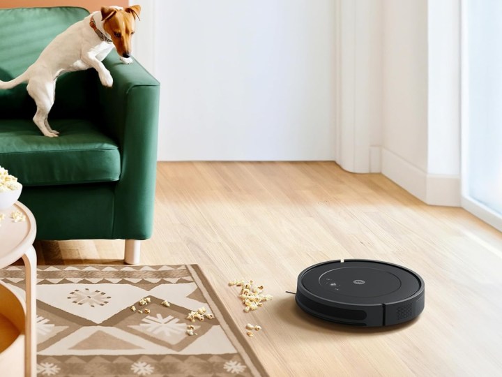 The iRobot Roomba Vacuum and Mop Combo Y0140 cleaning popcorn off the floor.