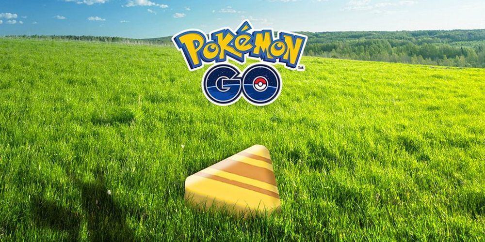 Candy XL from Pokémon Go on grass with the Pokémon Go logo above.