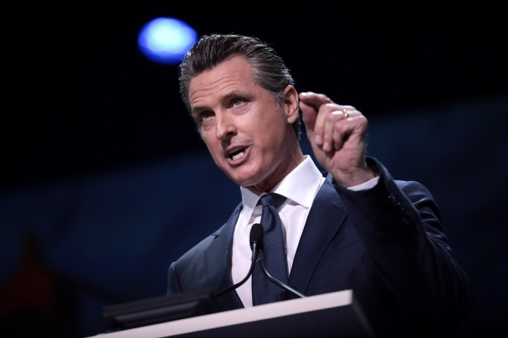 California Governor Gavin Newsom speaking at a lectern.