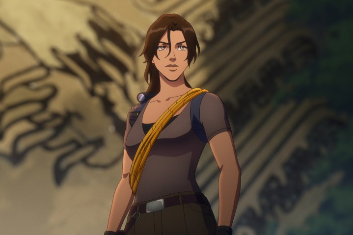 Lara Croft stands with a rope slung across her chest in Tomb Raider: The Legend of Lara Croft.