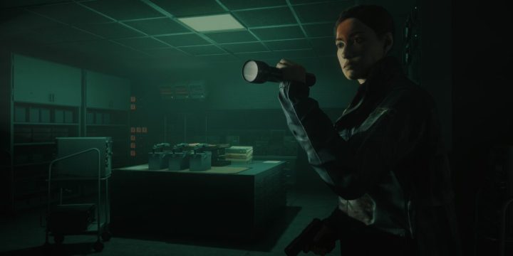 Agent Estevez using a flashlight in an office setting.