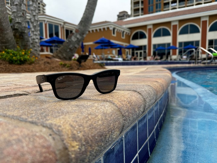 Ray-Ban Meta smart glasses placed by a pool.