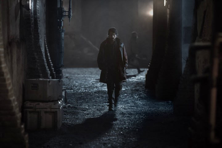 Cassian Andor walks through an alleyway in Andor season 1.