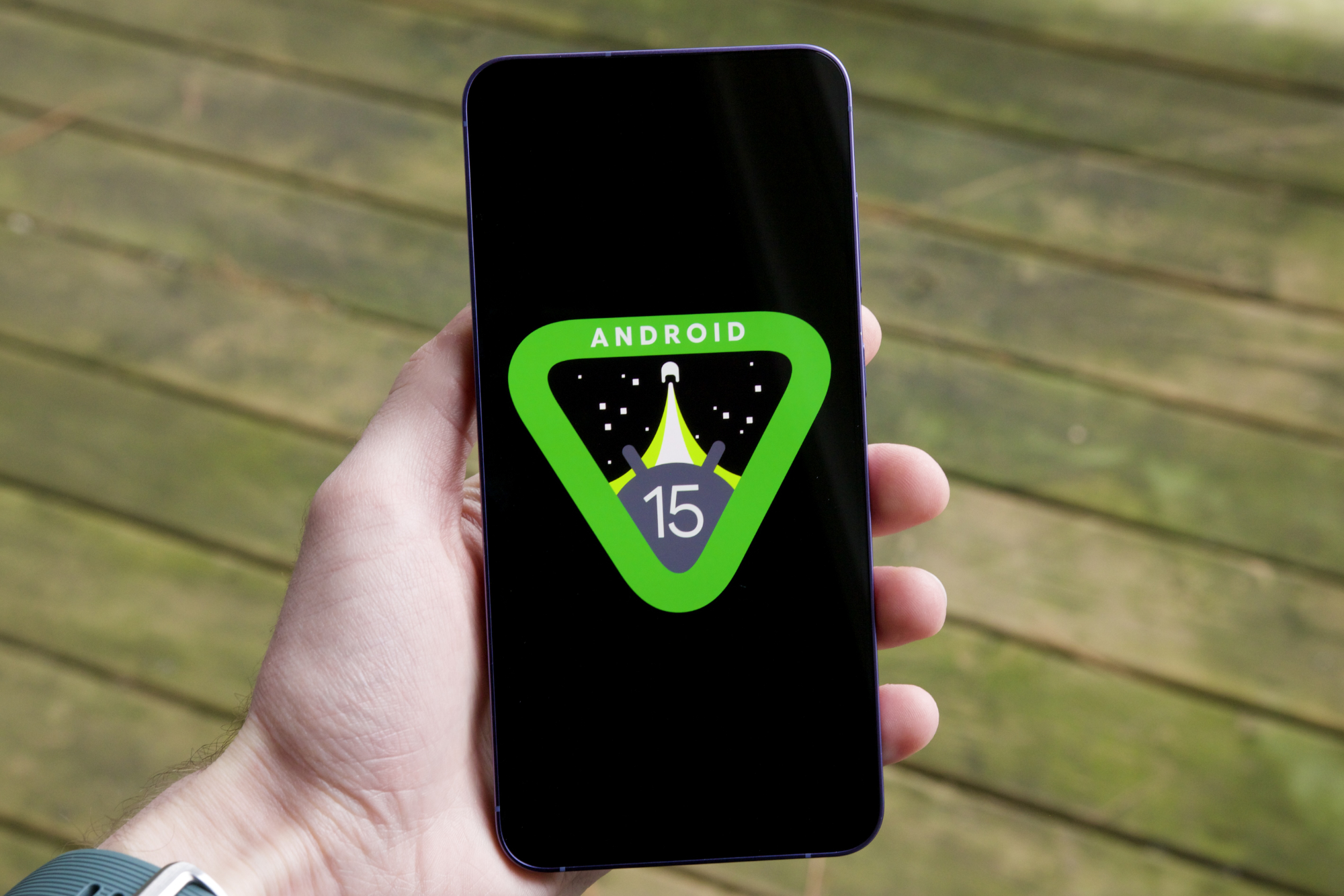 The Android 15 logo on a smartphone.