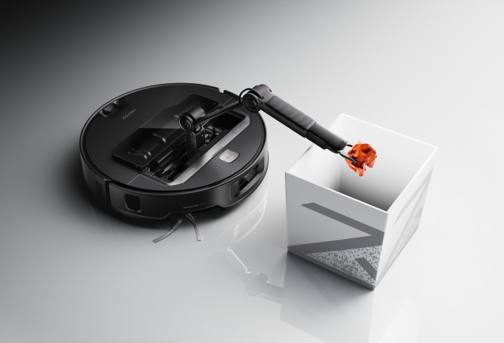 The Roborock Z70 lifting an object and depositing it.