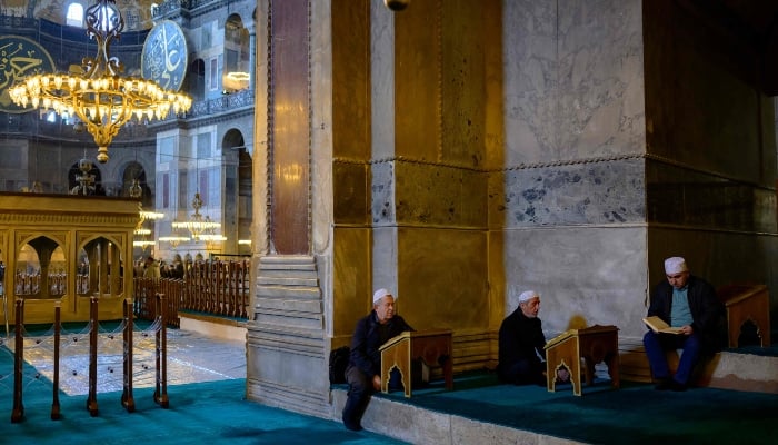 Visitors reading the Holy Quran in Hagia Sophia Grand Mosque, April 14, 2025. — AFP