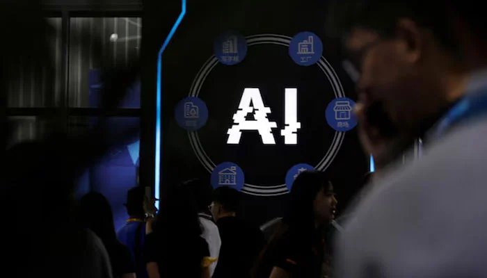 Visitors stand near a sign of artificial intelligence at an AI robot booth at Security China, an exhibition on public safety and security, in Beijing, China June 7, 2023. — Reuters